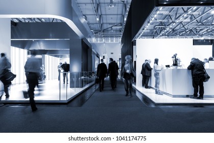 blurred people at a trade fair hall - Shutterstock ID 1041174775