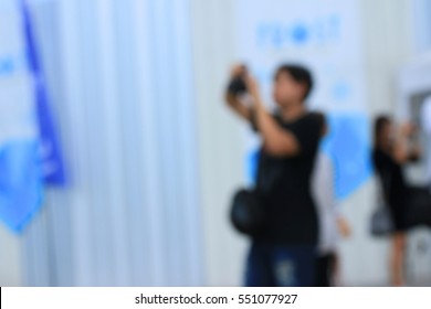 blurred people using a camera to take photo