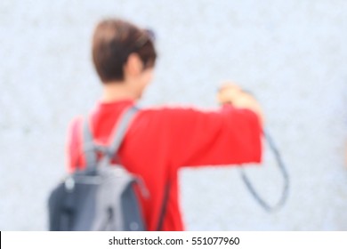 blurred people using a camera to take photo