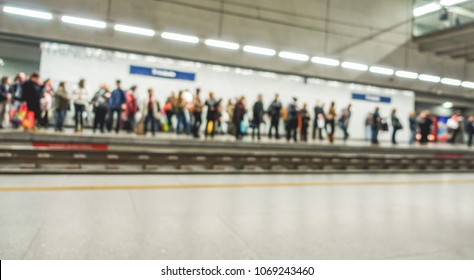 Blurred people waiting at train station - Citylife and transportation concept - Defocused image