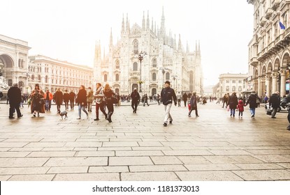 Blurred people walking in front of Duomo square in Milan - Defocused crowd on italian metropolis center - City lifestyle and tourism destination concept - Focus on cathedral church