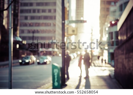 Blurred people walking on the street of Vancouver at sunset