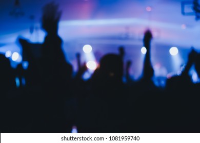 Blurred Photo Of Christian Worship God Together In Church  And Light Bokeh Effect.raised Hand And Praise The LORD. Concert Background.