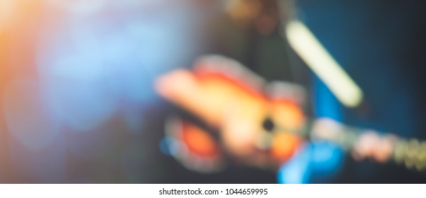 Blurred Photo Of Concert Stage Lights.Abstract Musical Background.Playing Guitar And Worship Concert Concept.Live Music Background.Music Festival.Instrument On Stage And Band.