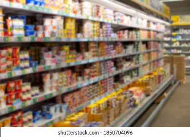 Blurred Photo Of Dairy Products On A Supermarket Shelf, No People Defocus. Empty Food Store