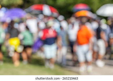 Blurred Photo Of Golfer And Audience On Green In Golf Tournament.