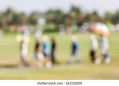 Blurred Photo Of Group Audience Moving On Green In Golf Tournament.