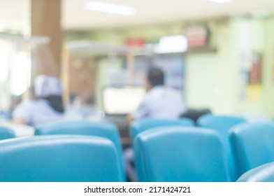 Blurred Photo Of Nurse And Male Nurse, Staff Or Hospital Workers Are Waiting For Serving Patients At Counter In Hospital With Protective Sheet Against Covid 19.