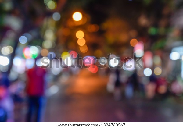 Blurred Photo\
- People walk the night market on the streets in Hanoi, Vietnam.\
Happy to shopping, eat and\
drink.