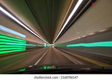 Blurred Photo Of Road Tunnel. Drowsy Driving. Tired Or Drunk Driver Behind The Wheel. Transportation. Night Driving Through The Dark Tunnel. Driver View.