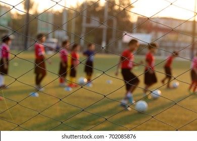 Blurred Photo Of Youth Training Football In The Football Practice Field. Sport Concept.