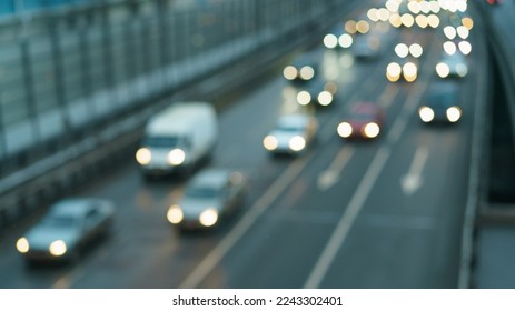 Blurred photography of cars motion. Big traffic in city. Urban highway filled out by cars. Rush hours. To be late. Work out. Cold blue with grey colors of the sunset in the January - Shutterstock ID 2243302401