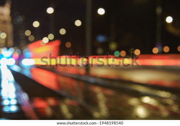 Blurred photography of cars motion. Big traffic in\
city. Urban highway filled out by cars. Rush hours. To be late.\
Work out. Suitable for greeting card design, background, postcard\
template, poster