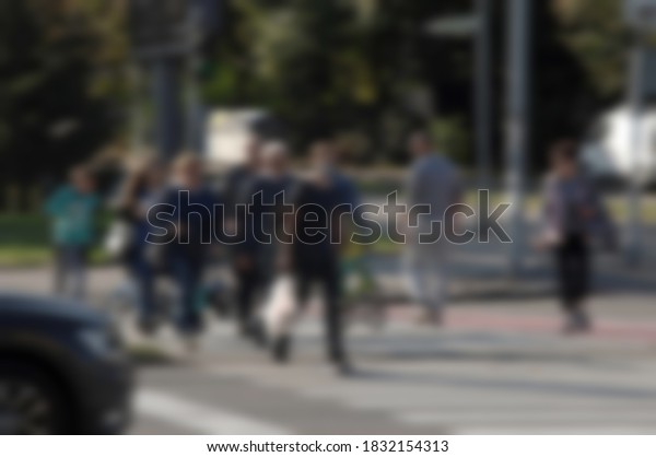 Blurred photography of people   walking across the\
street 