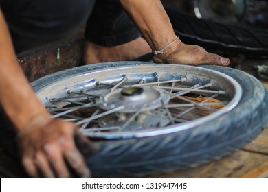 blurred photo,Motorcycle repair after a tire leak during a long journey. Modifying some parts of a motorcycle when it is used for a certain period of time by an expert technician.
Motorcycle repair