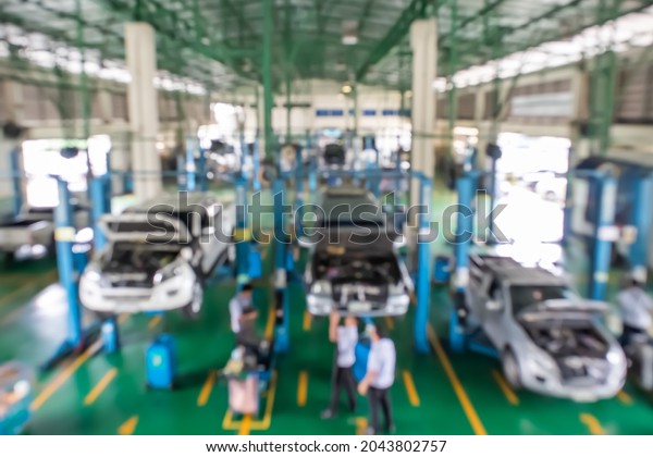 Blurred, Pickup truck mechanic repairing at\
service station center,\
Background
