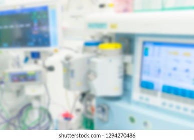 Blurred Picture Of Anesthesia Machine In Hospital Operating Room. Surgical Equipment At Medical Clinic..Anesthetic Machine In Hospital Operating Room. Gas Mixer With Computer Screen In Defocus.