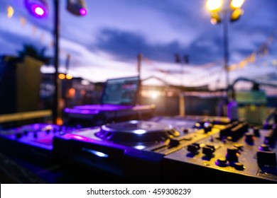 Blurred Picture Of Professional Sound System Equipment For Party Outdoor At Sunset - Defocused Image - Concept Of Nightlife With Music And Entertainment On The Beach - Original Color Lights