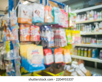 Blurred Picture Of Various Animal Feed Products Or Dry Food, Biscuit, Snack, Chew Bone For Dog And Cat In Plastic Box On Shelf In Pet Food Store