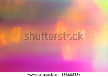 Blurred pink and yellow abstract lens flare background. Defocused glow effect. Illuminated bokeh