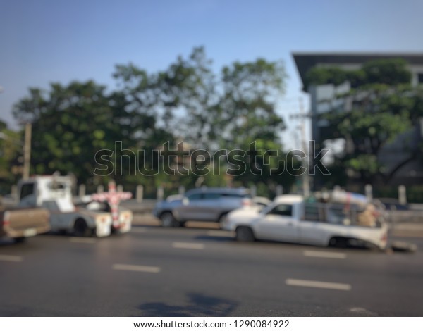Blurred of police department tow truck are\
towing white vehicle are broken on the road to prevent the danger\
of accident duplicate and deliver to the\
garage