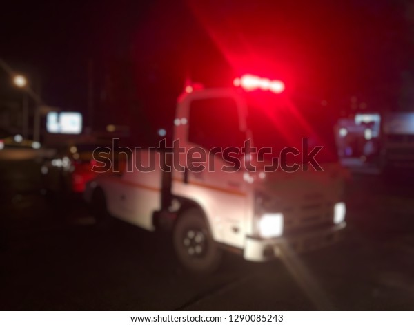 Blurred of police department tow truck are\
towing yellow vehicle are broken on the road to prevent the danger\
of accident duplicate and deliver to the\
garage