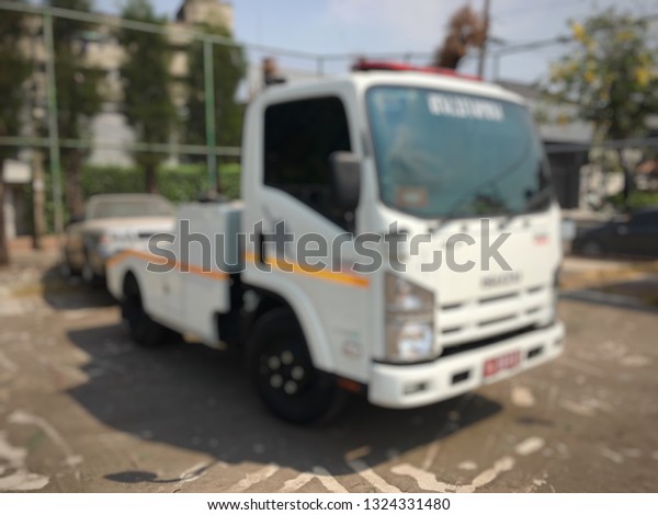 Blurred of police department tow truck are\
towing bronze vehicle are broken on the road to prevent the danger\
of accident duplicate and deliver to the\
garage