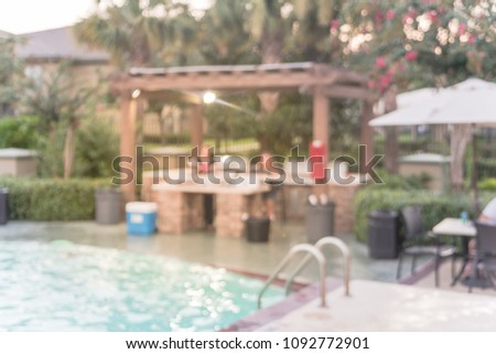 Blurred pool and BBQ party at apartment complex in America.