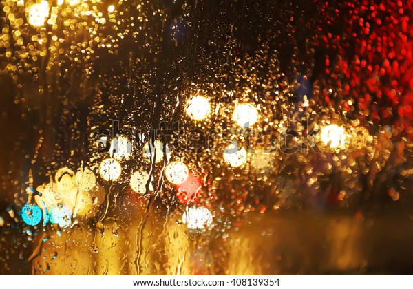 Blurred rain
background, view through wet car
window