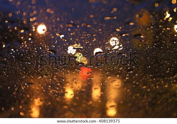 Blurred rain\
background, view through wet car\
window
