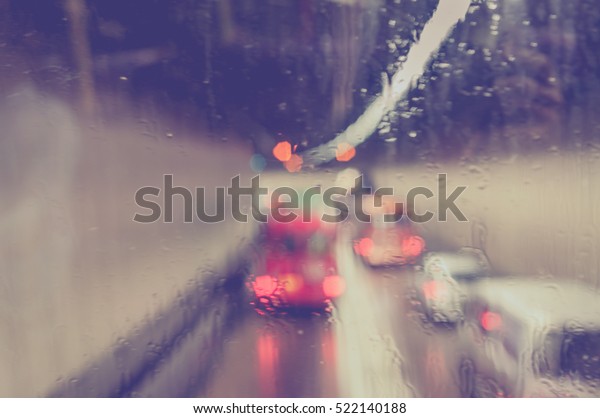 Blurred rain drop on the Bus glass,Urban view of
rain drops falls on bus
window
