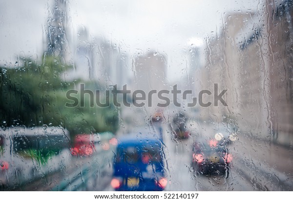 Blurred rain drop on the Bus glass,Urban view of
rain drops falls on bus
window
