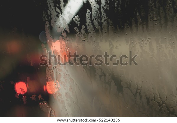 Blurred rain drop on the Bus glass,Urban view of\
rain drops falls on bus\
window
