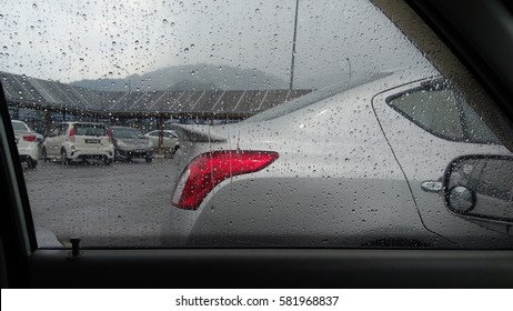 Blurred rain drop on the car glass background, water drops at the car window driver side, vintage color

