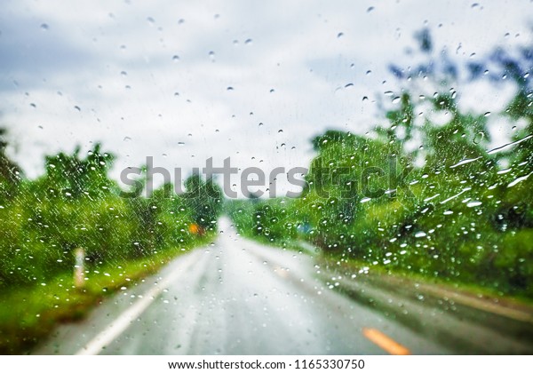 Blurred Rain Drop on a Moving Car,\
Blurred Vision from inside a Vehicle on a Strong Raining\
Day