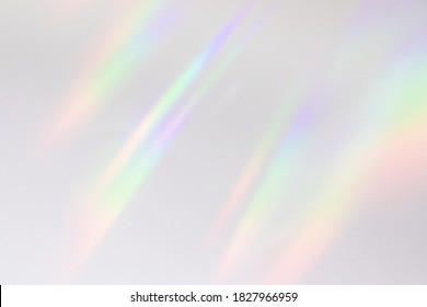 Blurred rainbow light refraction texture overlay effect for photo and mockups. Organic drop diagonal holographic flare on a white wall. Shadows for natural light effects - Shutterstock ID 1827966959
