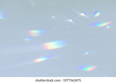 Blurred Rainbow Light Refraction Texture Overlay Effect For Photo And Mockups. Organic Drop Diagonal Holographic Flare On A White Wall. Shadows For Natural Light Effects