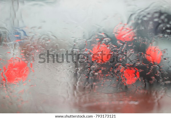 Blurred Red Brake Light and Raindrops During Raining\
, DOF