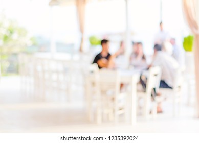 Blurred Restaurant Background, People Sitting In Garden Of A Restaurant Or Caffee Bar