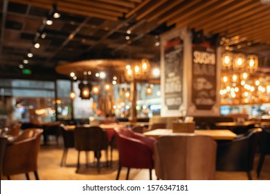 Blurred restaurant or cafe background. Tables and chairs in the lobby of restaurant. Visitors to restaurant for dinner. Cozy bokeh lightening. Beautiful bright interior. Blurred bokeh basic background - Powered by Shutterstock