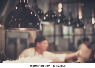 Blurred Restaurant Chef: Chef Cooking In The Open Kitchen, Customer Can See Cooking At Food Counter