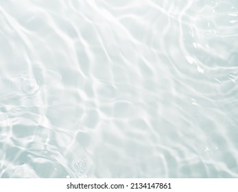 Blurred ripple water texture on white background. Shadow of water on sunlight. Mockup for product, spa or travel background. Marble water surface as wallpaper background - Shutterstock ID 2134147861