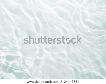 Blurred ripple water texture on white background. Shadow of water on sunlight. Mockup for product, spa or travel background. Marble water surface as wallpaper background