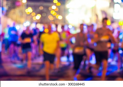 Blurred Runners Shortly After The Start At The Night Run.  Bokeh Background.