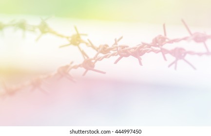 Blurred Rusty barbed wire on blurred background.Blurry barbed wire made with color filter.