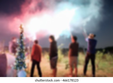 Blurred scene friend celebration playing sparkler on field - Powered by Shutterstock