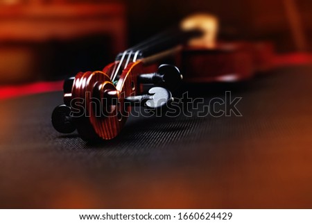 Blurred Scroll of violin put on background,vintage and art tone,blurry light around