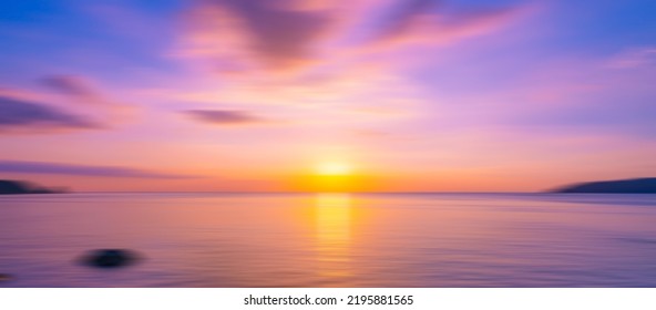 Blurred sea background at sunset  Abstract natural background   texture motion blur panoramic view sunrise over ocean Dark sky sunlight   deep dark water sea background
