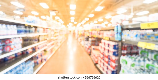 Blurred Selection Of Canned Foods, Tuna, Kosher Foods, Water, Natural Beverage, Water Filters On Shelves In Store At Humble, Texas, US. Defocused Background Variety Product Supermarket. Panorama Style