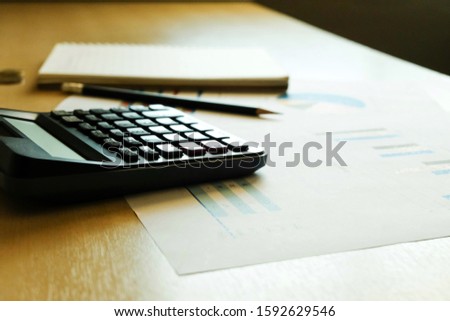 Blurred selective focus, Cost reduction calculating on financial, tax and business infographic graph pie chart. Tax and expense cost saving for personal and enterprise corporate concept.